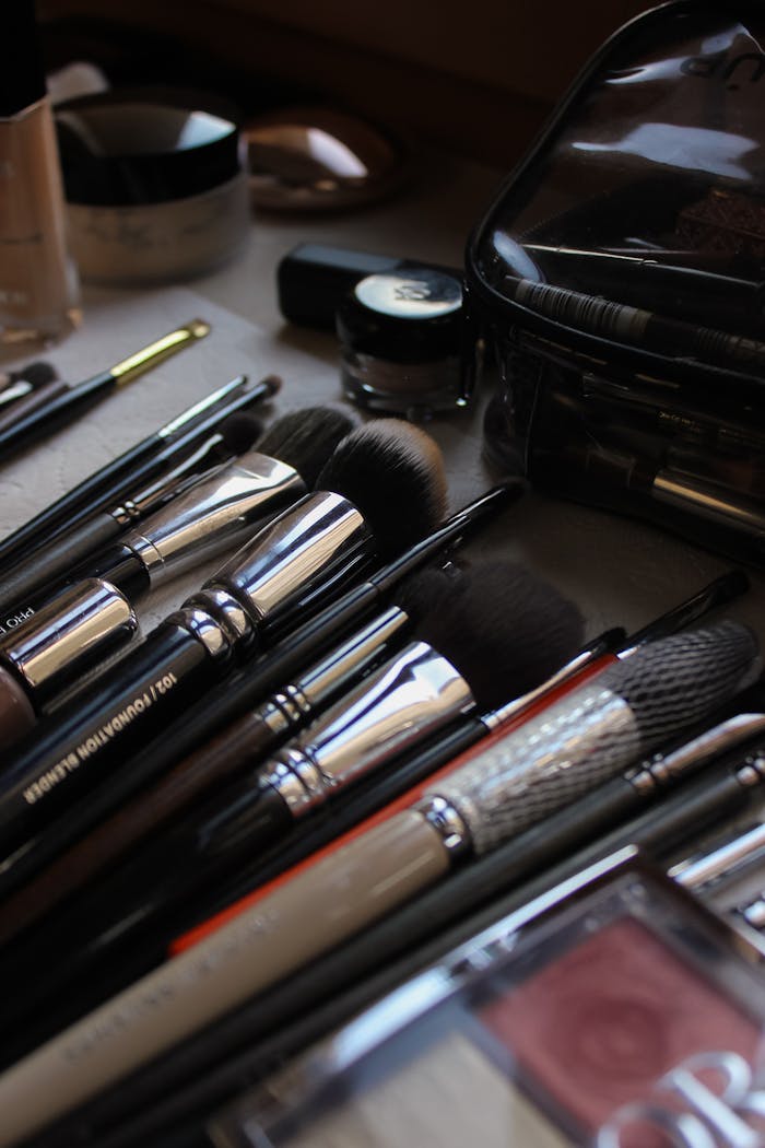 A stylish flat lay of various makeup brushes and cosmetics, showcasing beauty essentials.